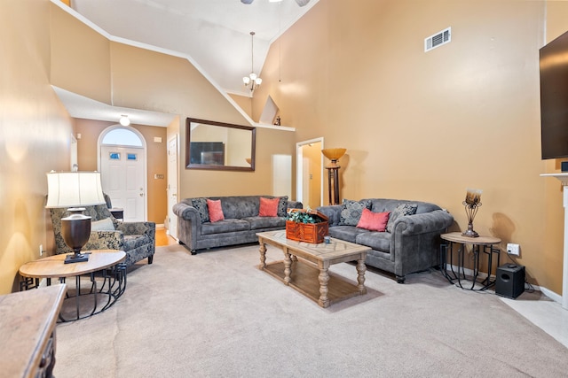 living room with high vaulted ceiling and light colored carpet