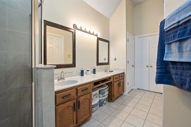 bathroom featuring tile patterned flooring, vanity, and walk in shower