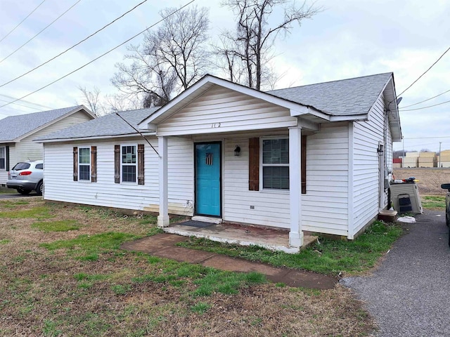 view of front of house featuring covered porch and roof with shingles