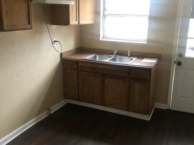 kitchen featuring sink and dark hardwood / wood-style flooring