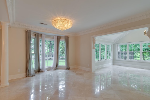 spare room featuring ornate columns, a healthy amount of sunlight, baseboards, and a notable chandelier