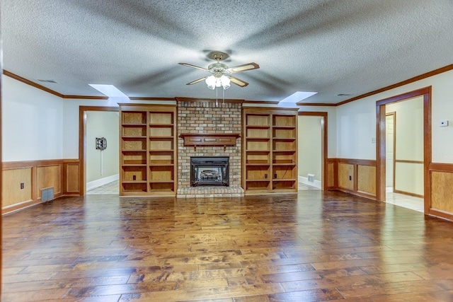 unfurnished living room featuring crown molding, dark hardwood / wood-style floors, and a textured ceiling