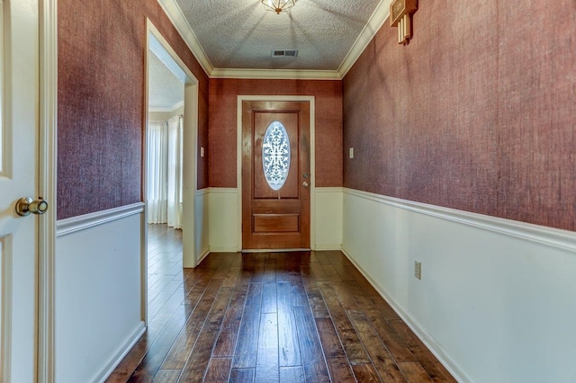 doorway to outside with hardwood / wood-style flooring, crown molding, and a textured ceiling