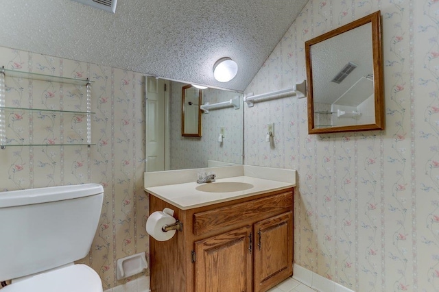 bathroom with vanity, vaulted ceiling, a textured ceiling, and toilet