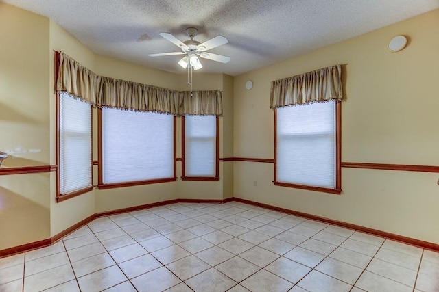 empty room featuring ceiling fan and a textured ceiling