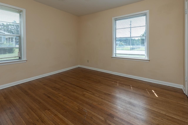 spare room with dark hardwood / wood-style floors