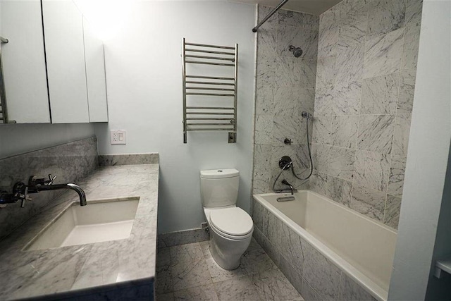 full bathroom with tiled shower / bath, radiator, vanity, and toilet