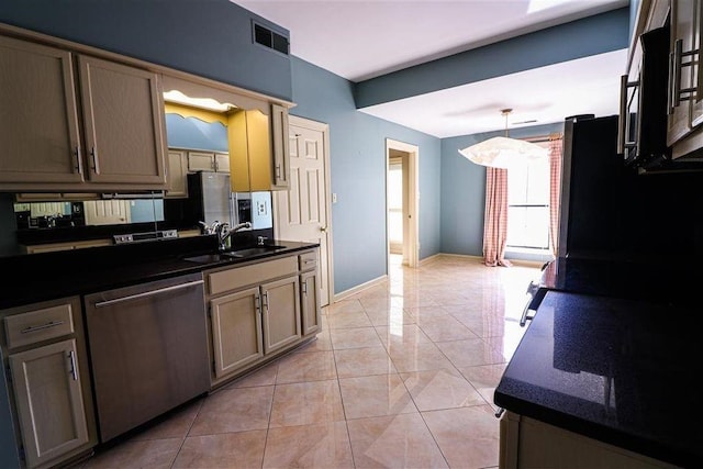 kitchen featuring stainless steel dishwasher, sink, hanging light fixtures, and light tile patterned floors