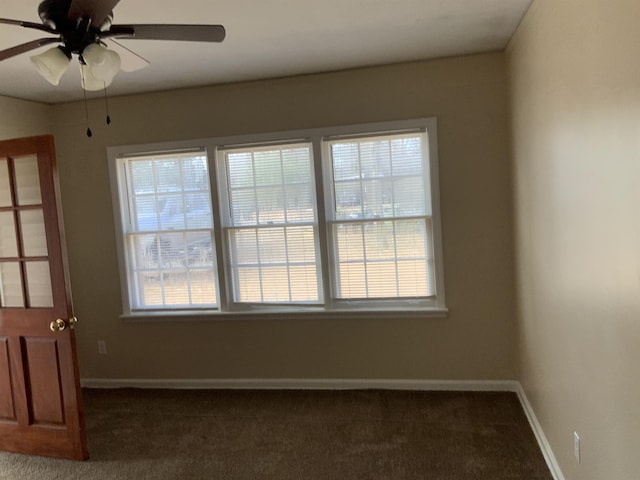 carpeted empty room with a healthy amount of sunlight and ceiling fan