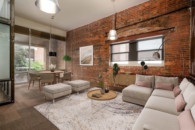 living room featuring brick wall and carpet flooring