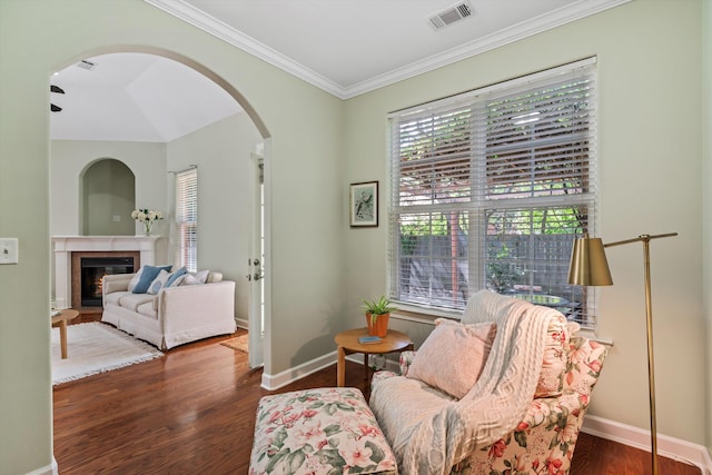 sitting room with crown molding, dark wood-type flooring, and plenty of natural light