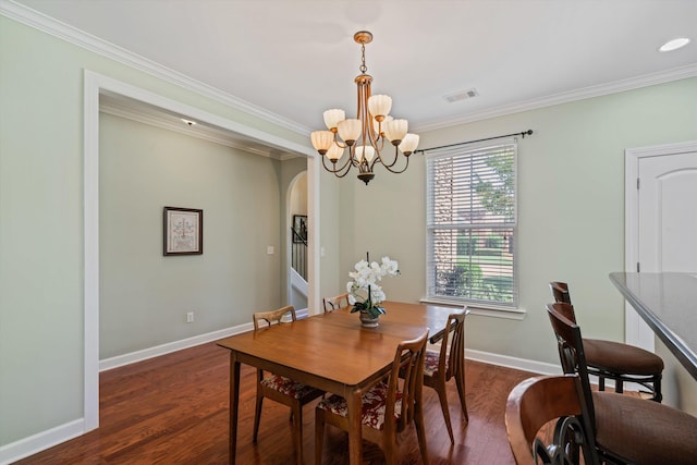 dining space with an inviting chandelier, ornamental molding, and dark hardwood / wood-style floors