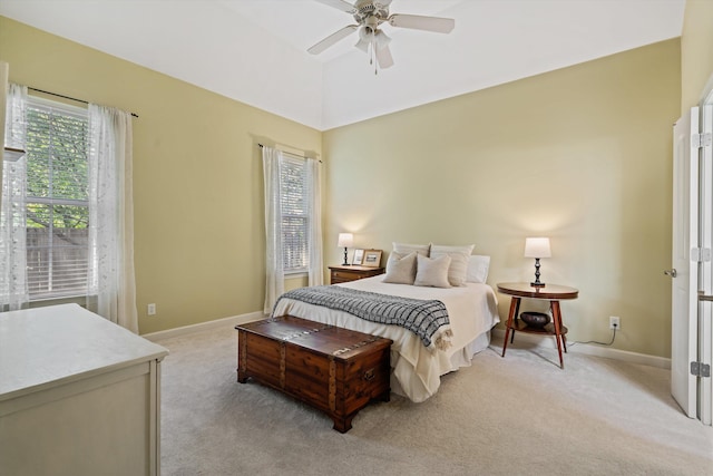 carpeted bedroom featuring multiple windows and ceiling fan