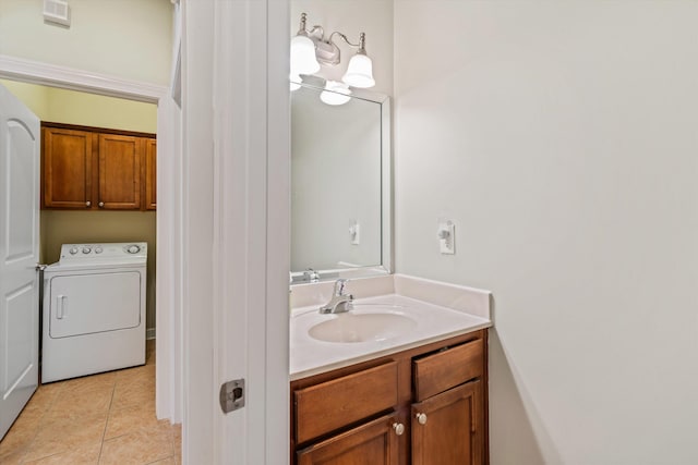 bathroom featuring vanity, washer / clothes dryer, and tile patterned floors