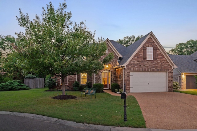 view of front facade featuring a garage and a lawn