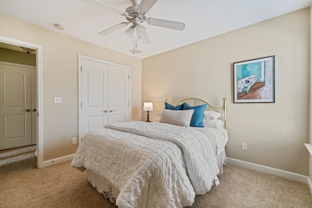 bedroom featuring light carpet, a closet, and ceiling fan