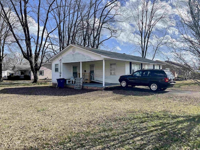 single story home with a porch and a front yard