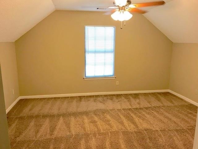 additional living space featuring ceiling fan, vaulted ceiling, and carpet