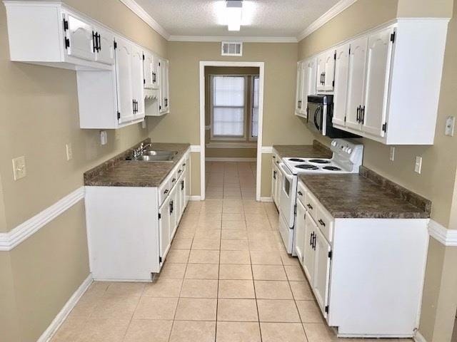 kitchen featuring white cabinetry, light tile patterned floors, sink, and white range with electric stovetop