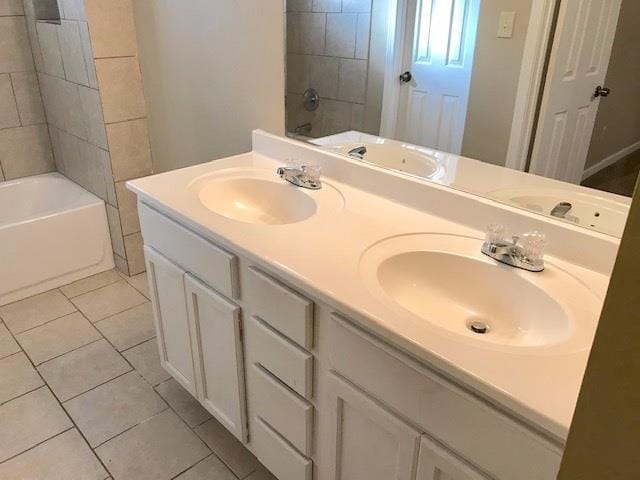 bathroom featuring vanity, tile patterned floors, and tiled shower / bath