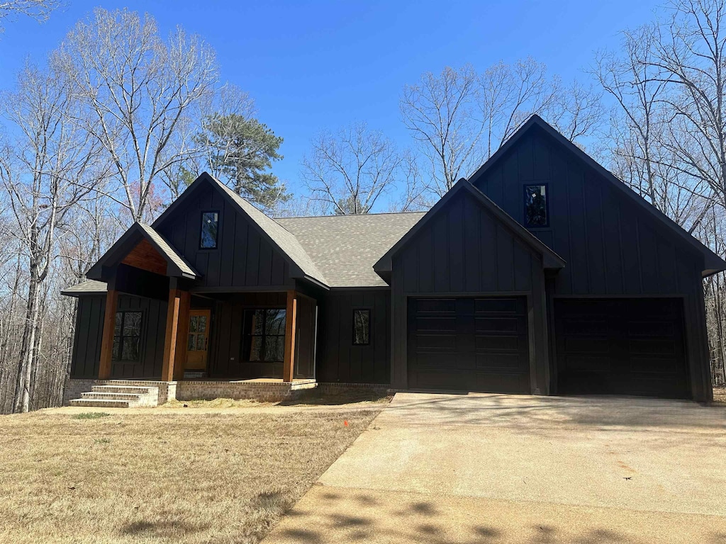 modern farmhouse style home featuring a garage and a porch