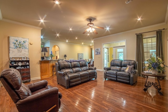 living room featuring ceiling fan, ornamental molding, and wood-type flooring