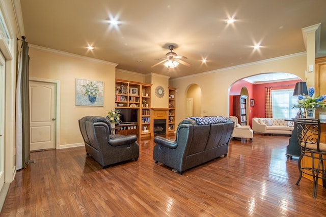 living room with crown molding, hardwood / wood-style floors, and ceiling fan