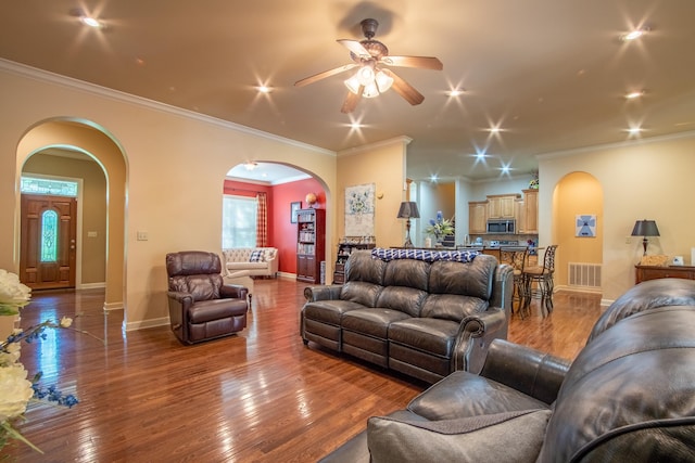 living room with hardwood / wood-style flooring and ornamental molding