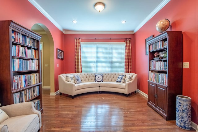 living area featuring crown molding and hardwood / wood-style floors