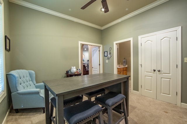 dining area with crown molding, ceiling fan, and light carpet