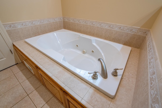 bathroom with tile patterned floors and tiled bath