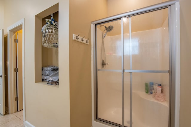 bathroom featuring tile patterned flooring and a shower with door