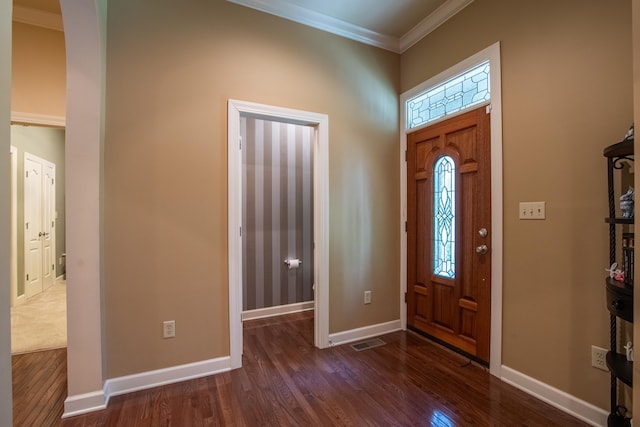 foyer featuring ornamental molding and dark wood-type flooring