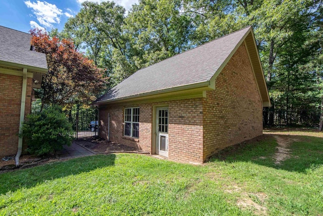 view of side of property with a yard