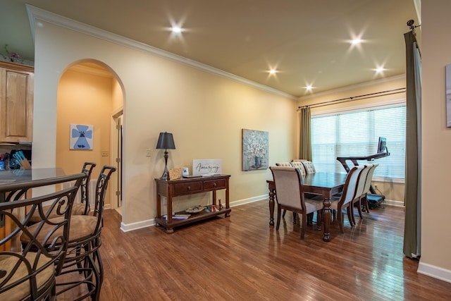 dining area with crown molding and dark wood-type flooring