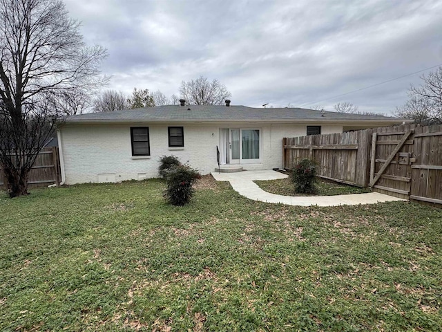 rear view of house with a lawn