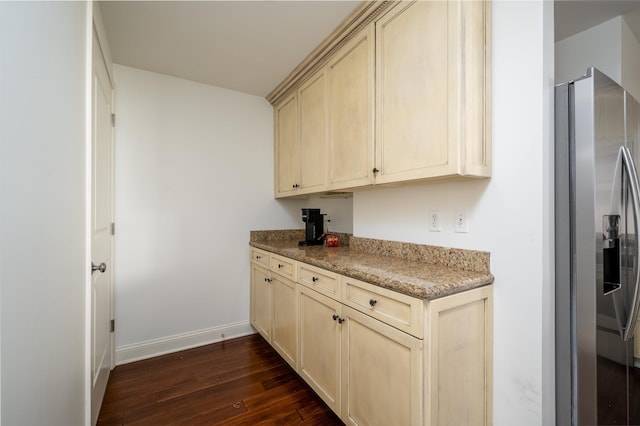 kitchen featuring stainless steel refrigerator with ice dispenser, dark wood-type flooring, and light stone counters