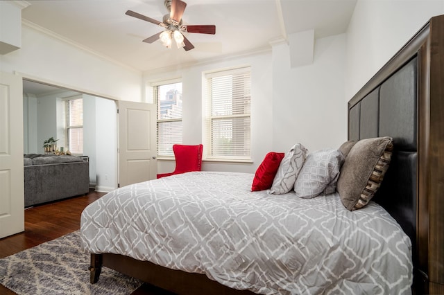 bedroom featuring crown molding, ceiling fan, and dark hardwood / wood-style flooring