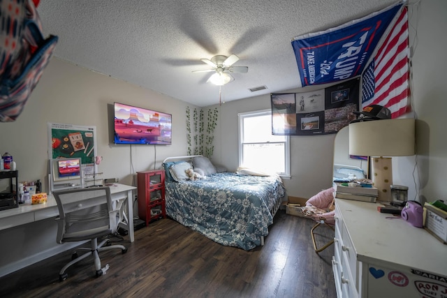 bedroom featuring a textured ceiling, dark wood finished floors, visible vents, and a ceiling fan