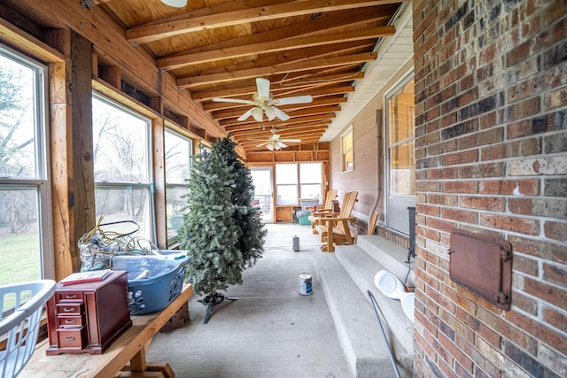 unfurnished sunroom with wood ceiling, beam ceiling, and ceiling fan
