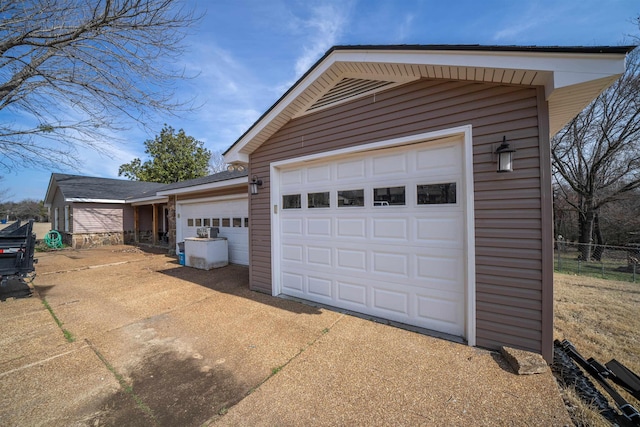 garage with concrete driveway