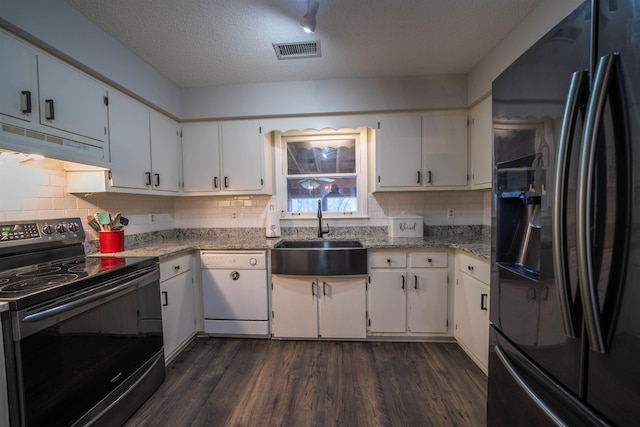 kitchen featuring range with electric cooktop, dishwasher, black fridge with ice dispenser, under cabinet range hood, and a sink