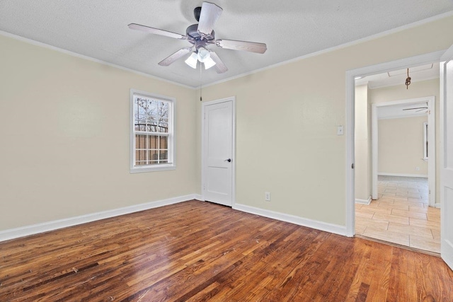 spare room with crown molding, ceiling fan, a textured ceiling, and light hardwood / wood-style flooring