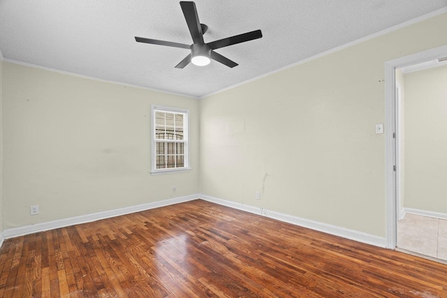 spare room with ceiling fan, ornamental molding, dark hardwood / wood-style flooring, and a textured ceiling