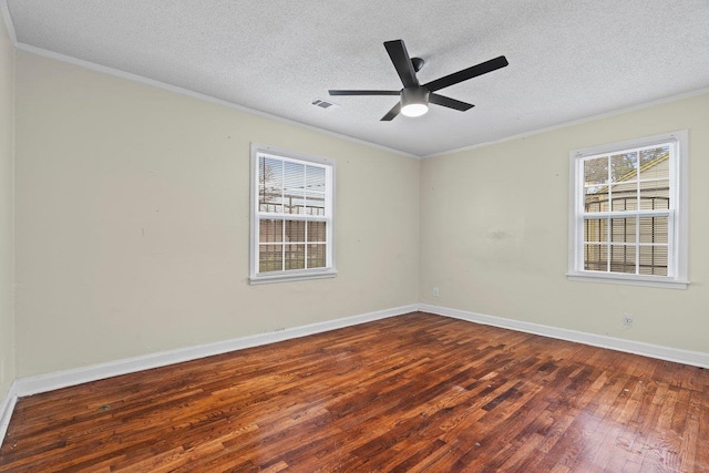 unfurnished room with ceiling fan, crown molding, dark wood-type flooring, and a textured ceiling