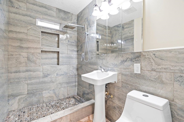 bathroom featuring tiled shower, tile walls, and toilet