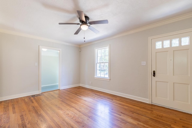 entrance foyer with crown molding, ceiling fan, a textured ceiling, and light wood-type flooring