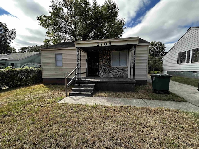 view of front of property with covered porch and a front yard