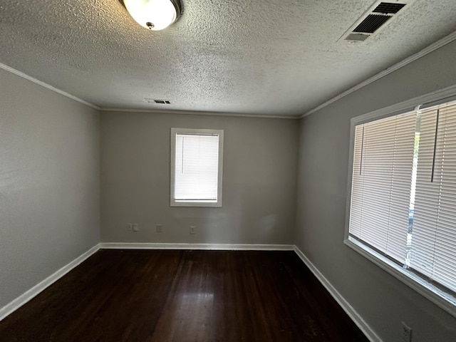 empty room with dark wood-type flooring, ornamental molding, and a textured ceiling