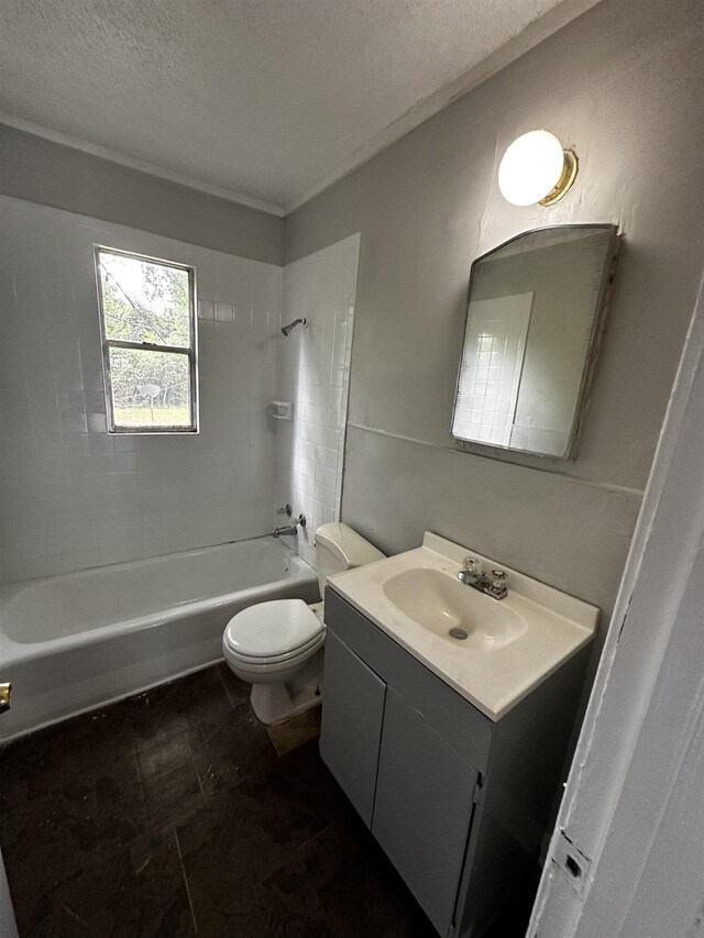 full bathroom featuring tiled shower / bath, vanity, toilet, and a textured ceiling